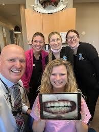 Can You Correct an Overbite Without Braces? 3 a group of people posing for a photo